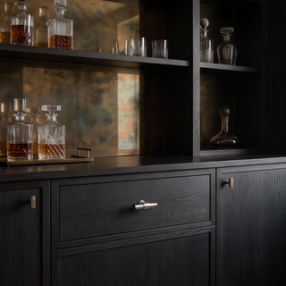 Brushed Nickel Kensington T-bar knob installed on a black wood bar cabinet drawer