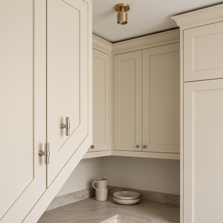 Brushed Nickel Kensington T-bar knobs installed on cream kitchen cabinet doors